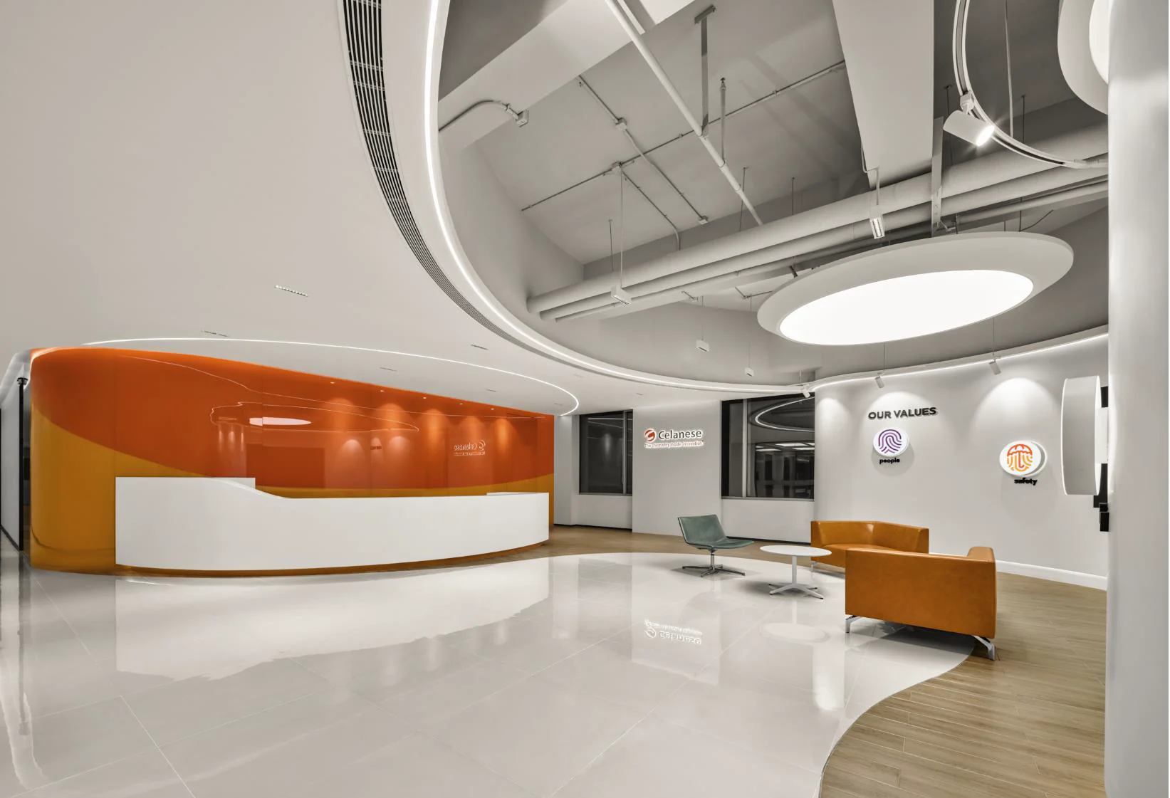 Curved orange reception and open collaboration space