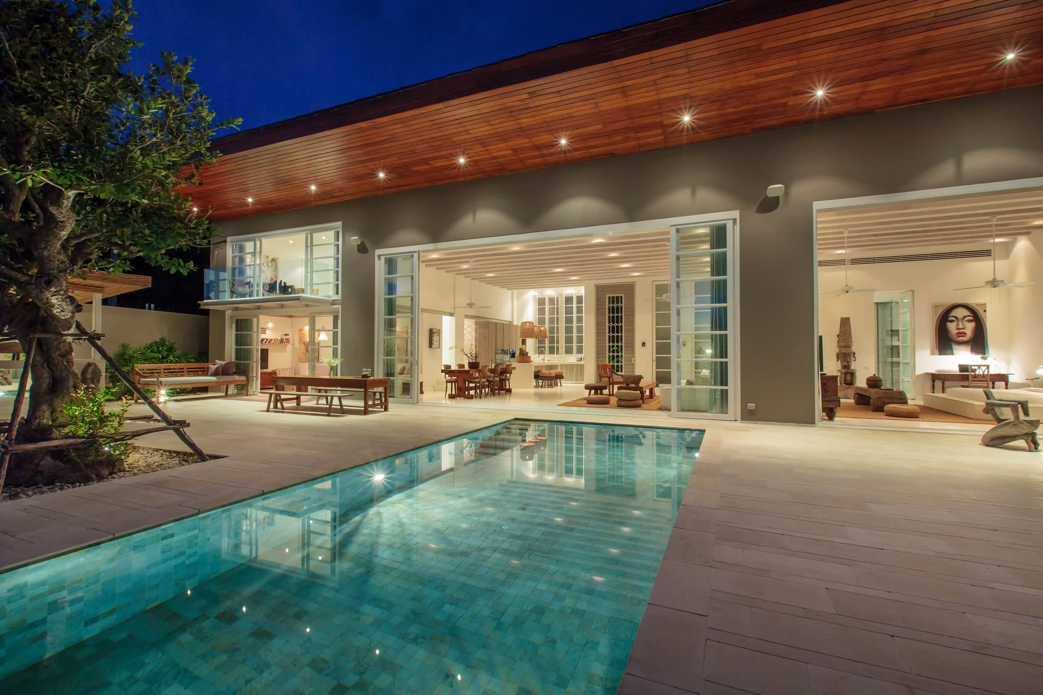 Tropical private villa opening to a pool and garden