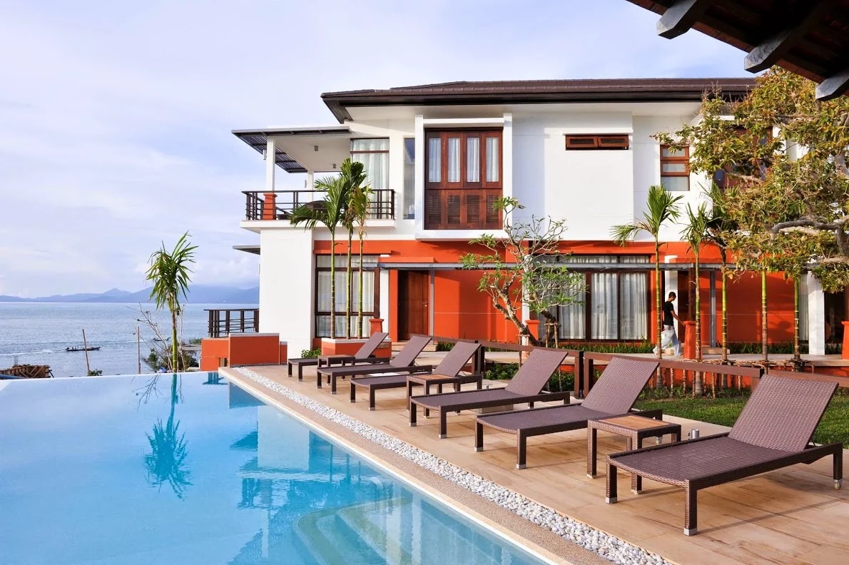 Tropical luxury villa opening to an illuminated pool